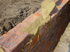 Cement mortar being spead with trowel for even adherance