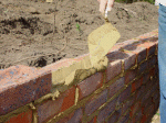 Bricklaying sequence 1 - The cement mortar is applied to the course of bricks