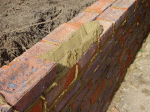 The mortar bed ready to take the brepared brick